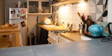 Striking Turquoise Cabinets Transform a Cramped, Dark Kitchen